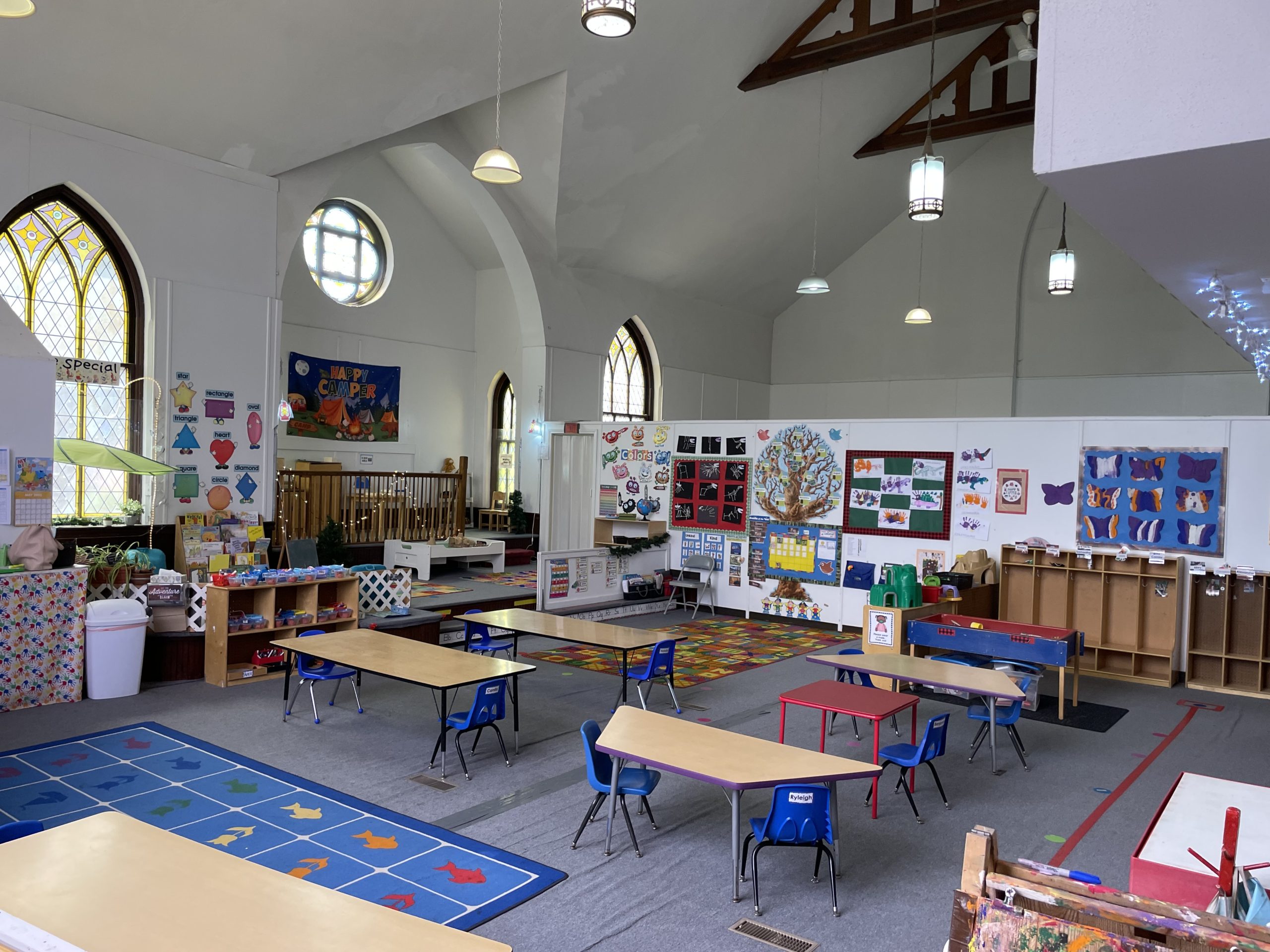 preschool classroom featuring toys, activities, and brightly colored artworks decorating the walls