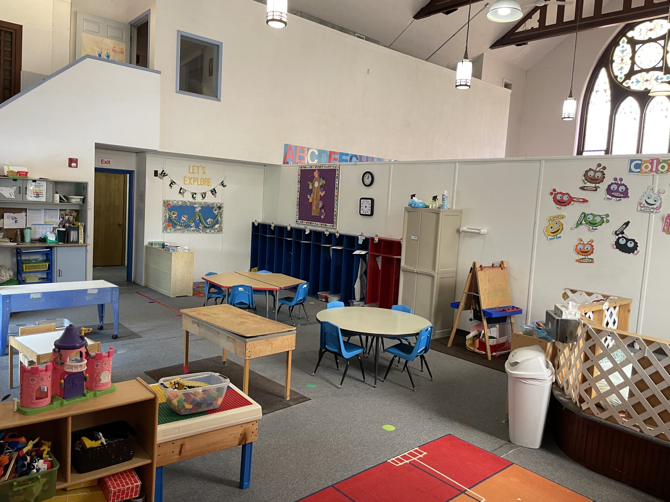 preschool classroom with colorful activities and artwork on the walls